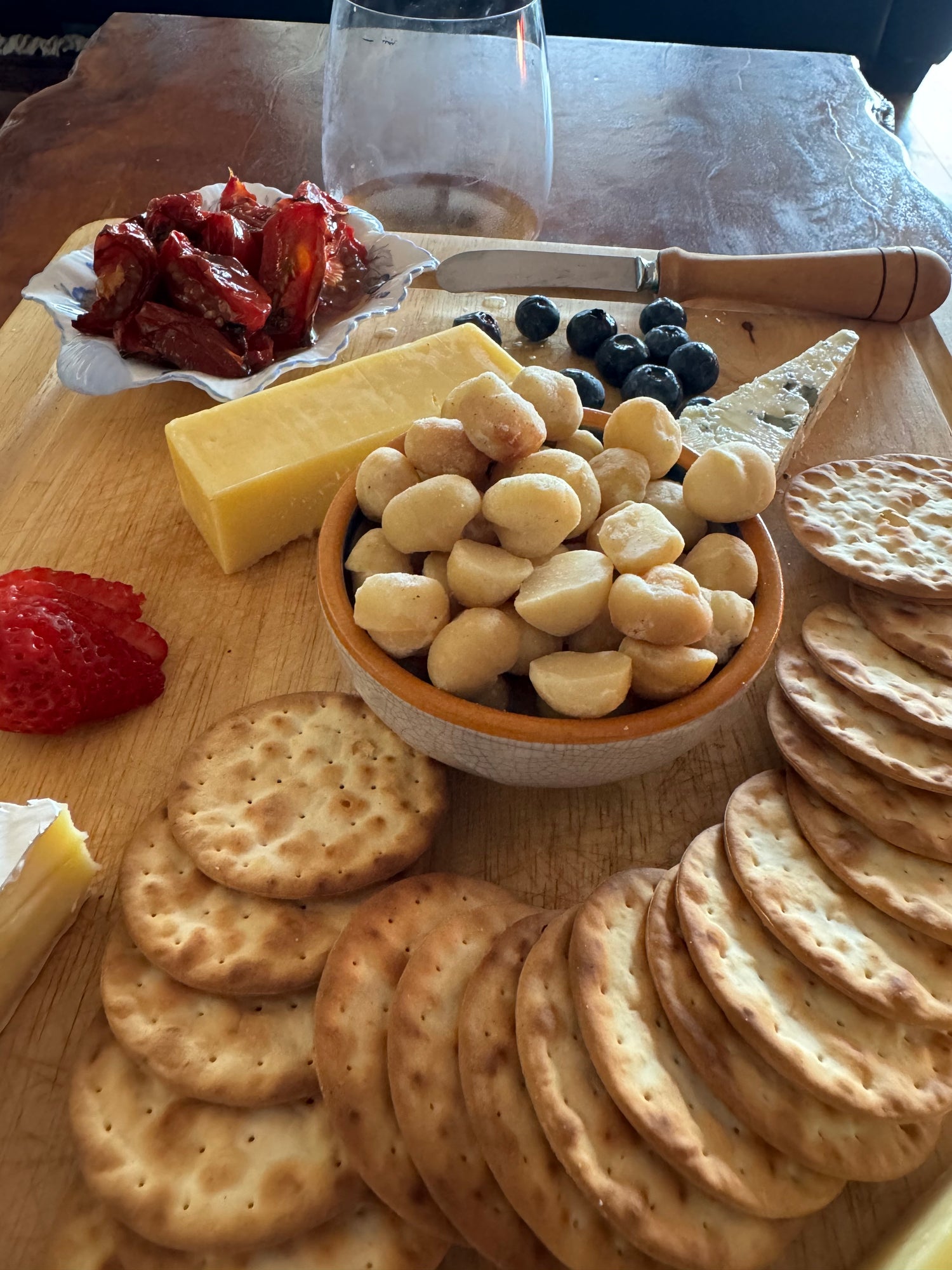 Cheese platter with cheddar, roquefort and raw organic macadamias