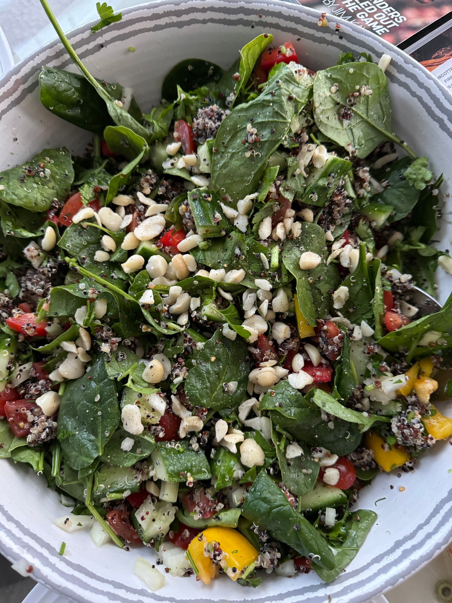 Mixed quinoa salad topped with macadamia pieces.